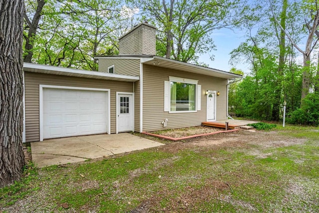 6429 S US Highway 45, Oshkosh, WI 54902 - view of front facade with a chimney and an attached garage