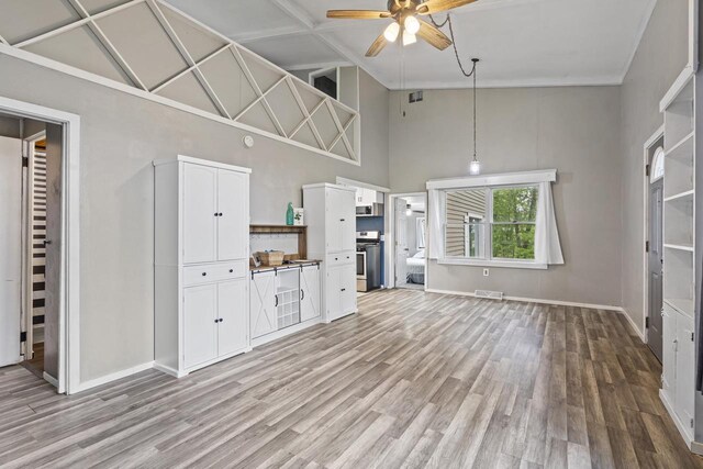 6429 S US Highway 45, Oshkosh, WI 54902 - unfurnished living room featuring high vaulted ceiling, ceiling fan, light wood finished floors, and baseboards