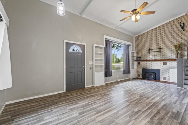 6429 S US Highway 45, Oshkosh, WI 54902 - unfurnished living room with wood finished floors, a ceiling fan, baseboards, ornamental molding, and brick wall