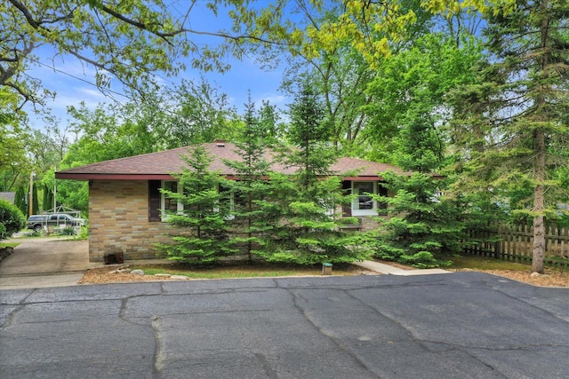 N8991 E Miramar Dr Unit N8993, East Troy, WI 53120 - view of property hidden behind natural elements with a shingled roof