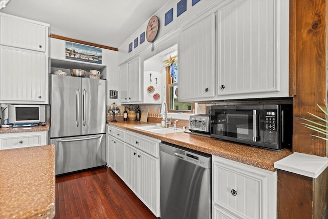 N8991 E Miramar Dr Unit N8993, East Troy, WI 53120 - kitchen featuring stainless steel appliances, a sink, dark wood-type flooring, and white cabinetry