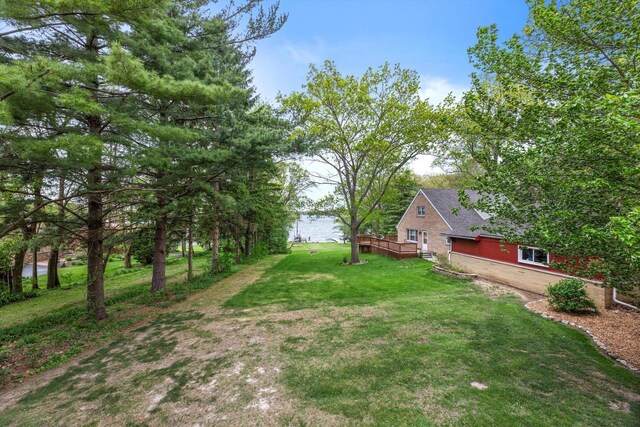 N8991 E Miramar Dr Unit N8993, East Troy, WI 53120 - view of grassy yard with a wooden deck