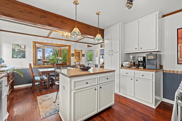 N8991 E Miramar Dr Unit N8993, East Troy, WI 53120 - kitchen with dark wood-type flooring, white cabinetry, a kitchen island, hanging light fixtures, and baseboards