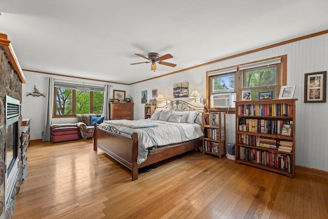 N8991 E Miramar Dr Unit N8993, East Troy, WI 53120 - bedroom with light wood-style flooring, crown molding, a stone fireplace, baseboards, and cooling unit