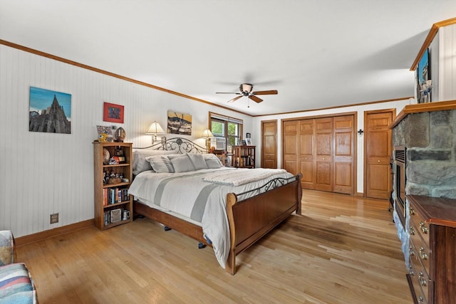 N8991 E Miramar Dr Unit N8993, East Troy, WI 53120 - bedroom featuring light wood finished floors, baseboards, ornamental molding, ceiling fan, and a stone fireplace