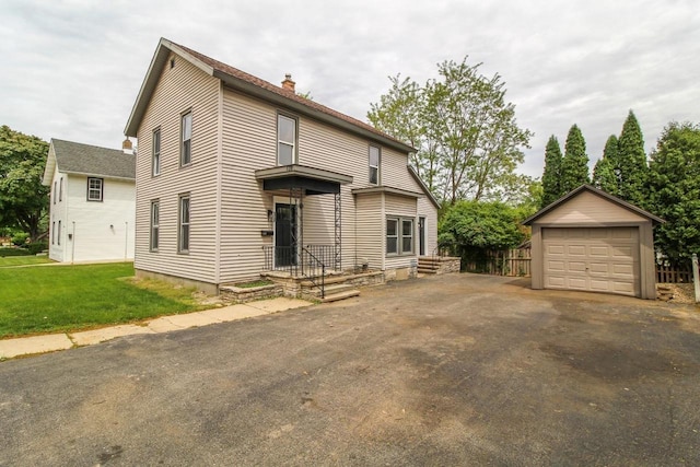 139 S Church St, Whitewater, WI 53190 - traditional home featuring a chimney, a detached garage, an outdoor structure, and a front lawn