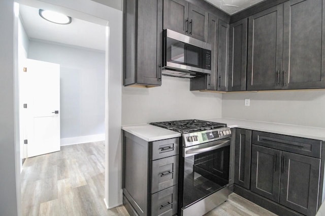 139 S Church St, Whitewater, WI 53190 - kitchen featuring appliances with stainless steel finishes, light countertops, light wood finished floors, and baseboards