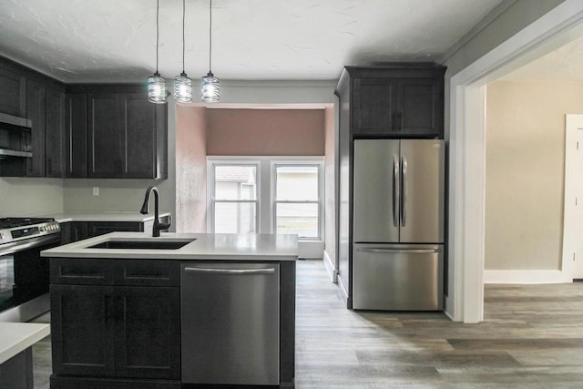 139 S Church St, Whitewater, WI 53190 - kitchen with stainless steel appliances, a sink, light countertops, and dark cabinetry