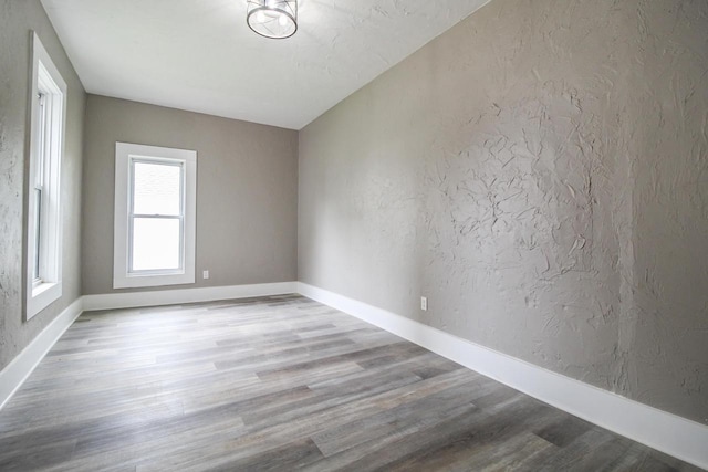 139 S Church St, Whitewater, WI 53190 - spare room featuring a textured wall, wood finished floors, and baseboards