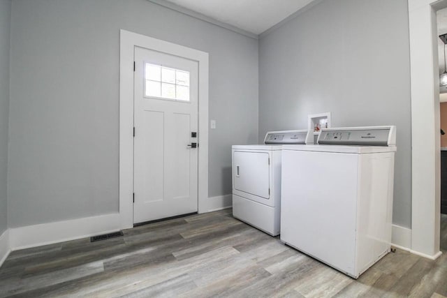 139 S Church St, Whitewater, WI 53190 - laundry room featuring washer and clothes dryer, wood finished floors, baseboards, and crown molding