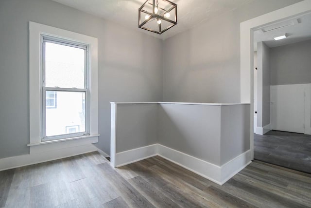 139 S Church St, Whitewater, WI 53190 - unfurnished dining area with a chandelier, wood finished floors, and baseboards
