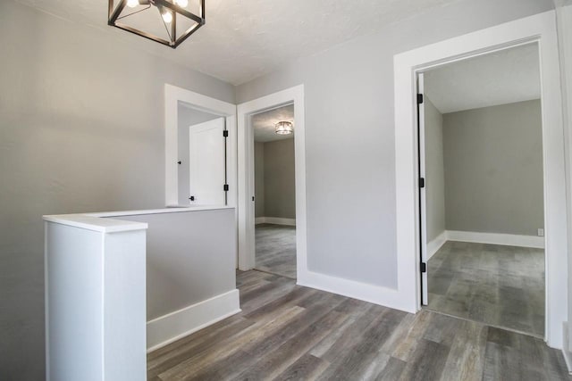 139 S Church St, Whitewater, WI 53190 - hall with wood finished floors, a chandelier, baseboards, and an upstairs landing