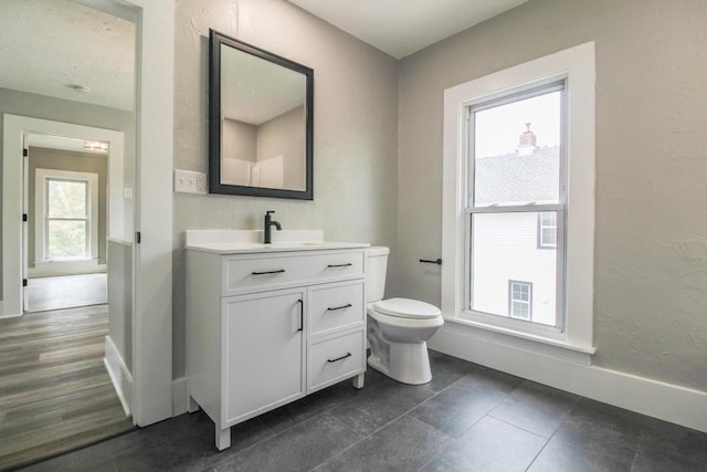 139 S Church St, Whitewater, WI 53190 - bathroom featuring vanity, baseboards, toilet, and tile patterned floors