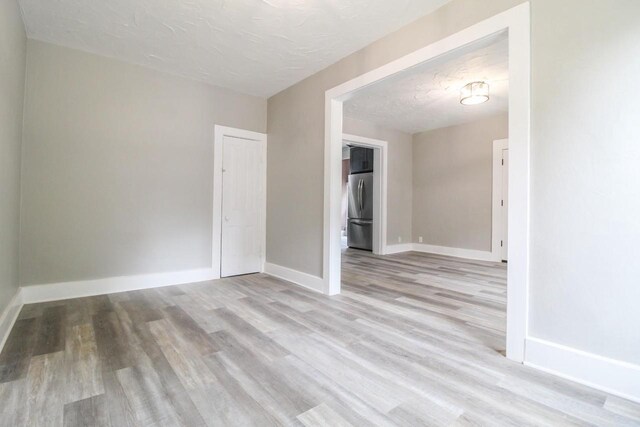 139 S Church St, Whitewater, WI 53190 - spare room featuring light wood-type flooring and baseboards