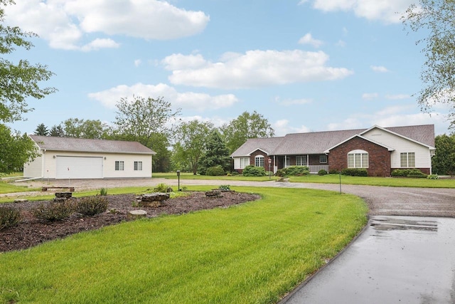 615 Jefferson St, Waterloo, WI 53594 - view of grassy yard with curved driveway and a garage
