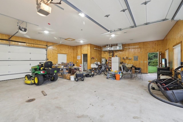 615 Jefferson St, Waterloo, WI 53594 - garage with a garage door opener and wood walls