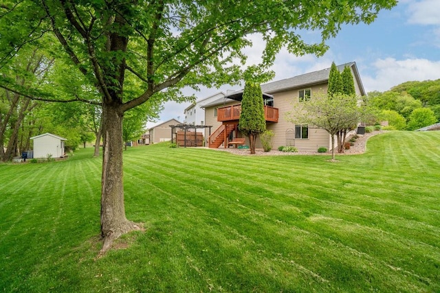 3829 Nicholas Dr, Menomonie, WI 54751 - view of green lawn featuring stairs, a deck, and an outdoor structure