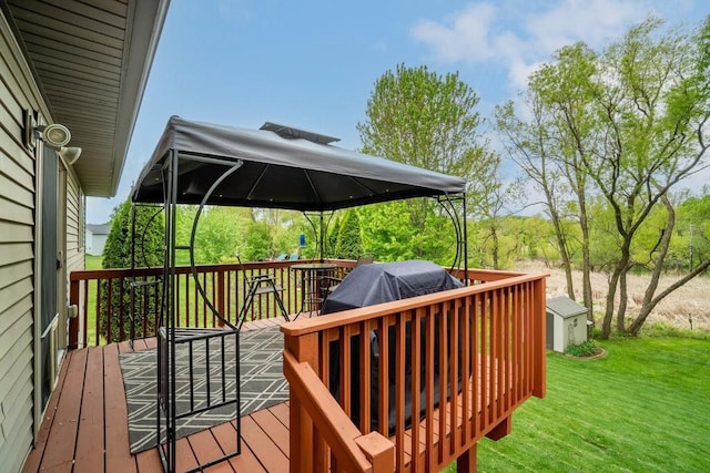 3829 Nicholas Dr, Menomonie, WI 54751 - wooden deck featuring a lawn, a gazebo, and an outbuilding
