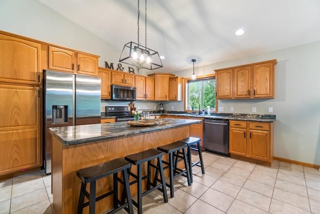 3829 Nicholas Dr, Menomonie, WI 54751 - kitchen featuring stainless steel appliances, light tile patterned flooring, a sink, a kitchen island, and a kitchen breakfast bar