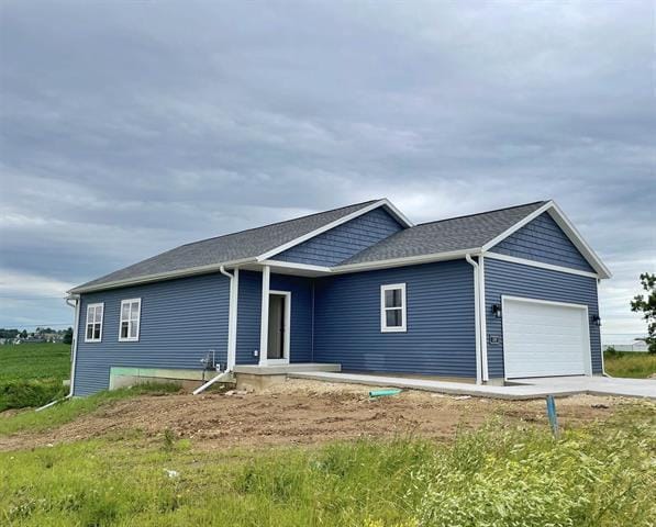 1257 Tivoli Cir, Oregon, WI 53575 - view of front of property with an attached garage and concrete driveway