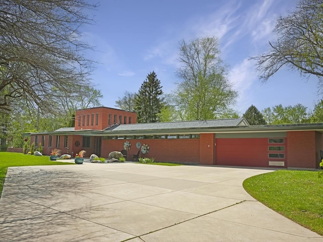 4701 4th St, Kenosha, WI 53144 - view of front of property with driveway, a garage, a front lawn, and brick siding