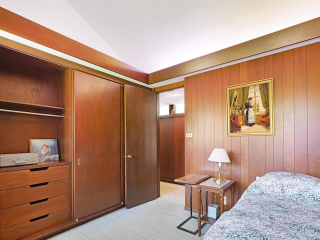 4701 4th St, Kenosha, WI 53144 - bedroom with light carpet, vaulted ceiling, wooden walls, and a closet