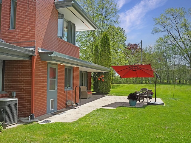 4701 4th St, Kenosha, WI 53144 - view of green lawn featuring a patio area and central air condition unit