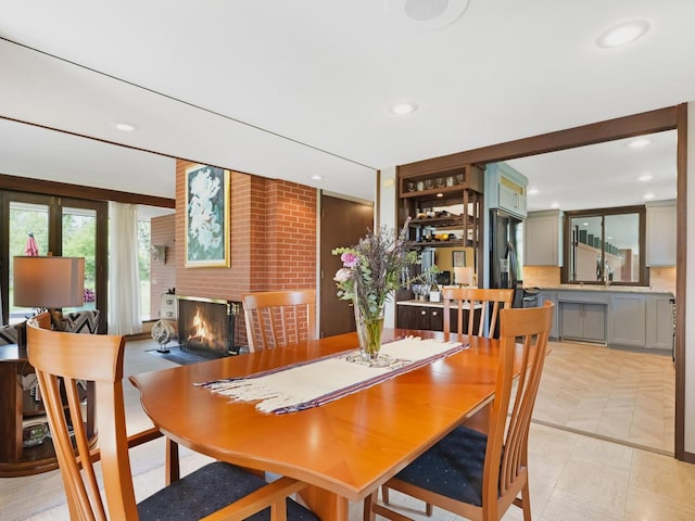 4701 4th St, Kenosha, WI 53144 - dining space with a brick fireplace, recessed lighting, and light floors