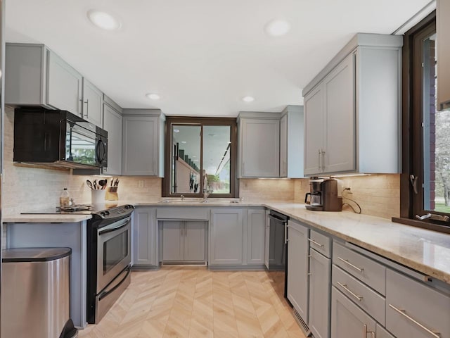 4701 4th St, Kenosha, WI 53144 - kitchen featuring gray cabinetry, black appliances, light stone countertops, recessed lighting, and decorative backsplash