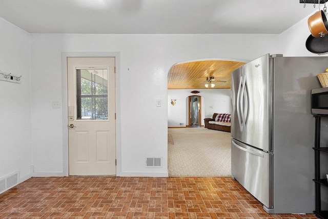 W6023 Lake Dr, Shawano, WI 54166 - kitchen with stainless steel appliances, arched walkways, brick patterned flooring, and baseboards