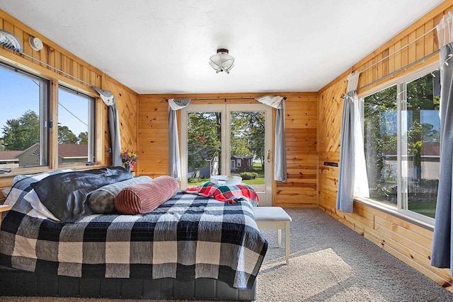 W6023 Lake Dr, Shawano, WI 54166 - carpeted bedroom featuring wood walls and multiple windows