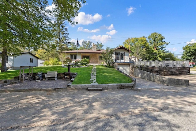 W6023 Lake Dr, Shawano, WI 54166 - view of front facade featuring a chimney, a front lawn, and a garage