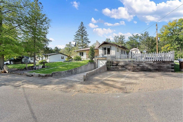 W6023 Lake Dr, Shawano, WI 54166 - bungalow-style home with an attached garage, driveway, and a front lawn