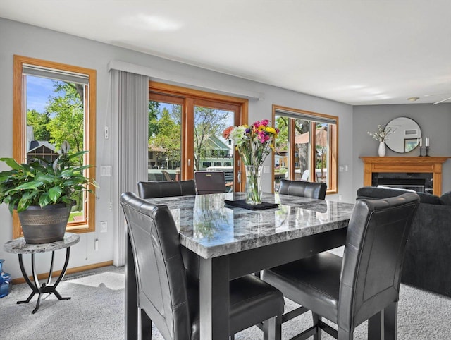 1306 Neponset Trl, Monona, WI 53716 - dining space with light carpet, healthy amount of natural light, a fireplace, and baseboards