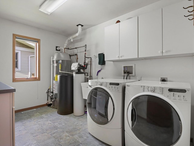1306 Neponset Trl, Monona, WI 53716 - laundry room featuring cabinet space, washing machine and dryer, baseboards, and water heater