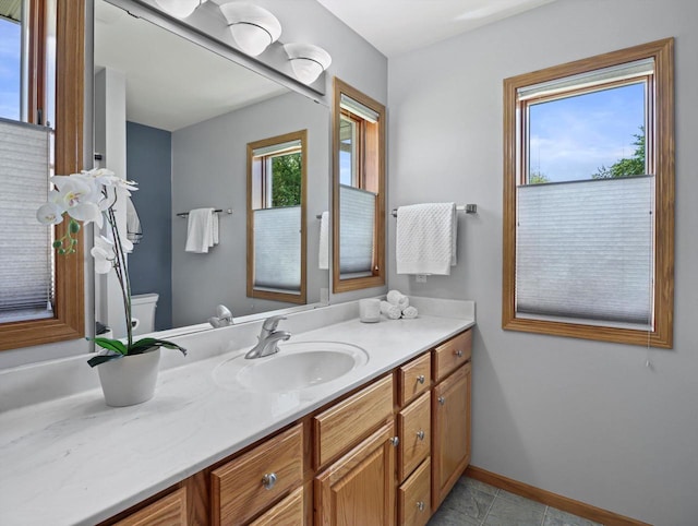 1306 Neponset Trl, Monona, WI 53716 - bathroom with toilet, vanity, baseboards, and tile patterned flooring