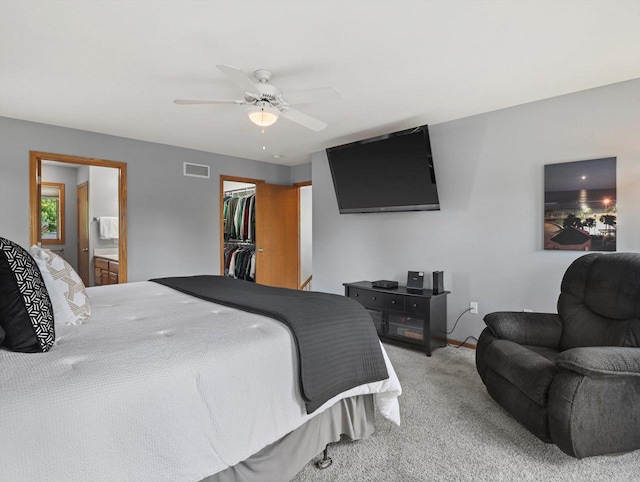 1306 Neponset Trl, Monona, WI 53716 - bedroom with carpet, a spacious closet, a closet, connected bathroom, and ceiling fan