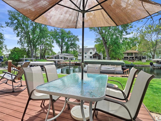 1306 Neponset Trl, Monona, WI 53716 - wooden deck featuring a water view, outdoor dining space, and a yard