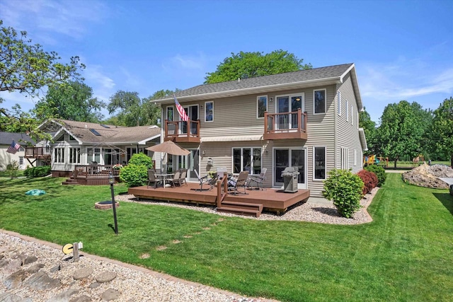 1306 Neponset Trl, Monona, WI 53716 - back of property with a balcony, a lawn, and a deck