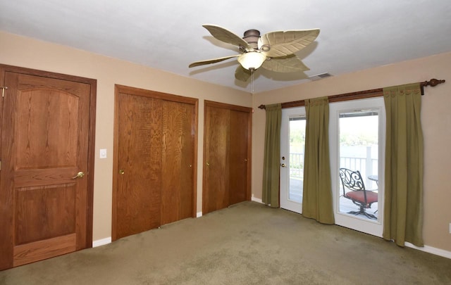 2462 Wallace Lake Rd, West Bend, WI 53090 - unfurnished bedroom with access to exterior, carpet flooring, multiple closets, and baseboards