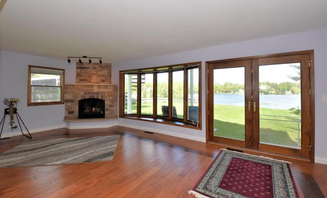 2462 Wallace Lake Rd, West Bend, WI 53090 - unfurnished living room featuring track lighting, healthy amount of natural light, and baseboards