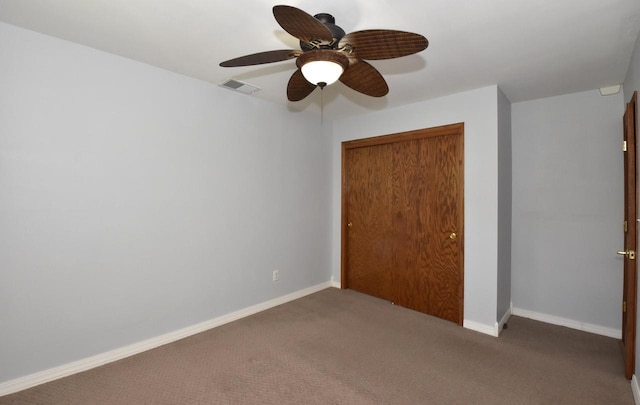 2462 Wallace Lake Rd, West Bend, WI 53090 - unfurnished bedroom featuring a closet, carpet floors, baseboards, and ceiling fan