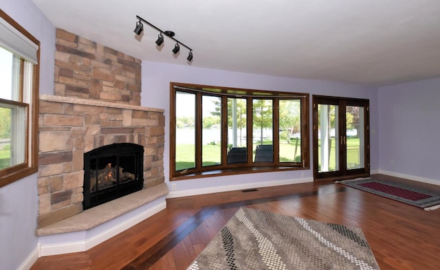 2462 Wallace Lake Rd, West Bend, WI 53090 - unfurnished living room featuring healthy amount of natural light, a fireplace, and baseboards