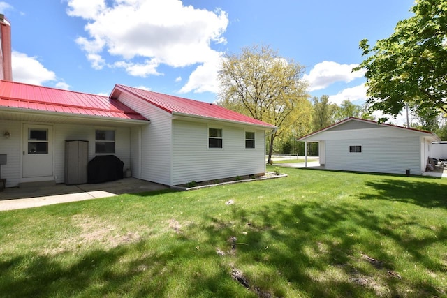 2462 Wallace Lake Rd, West Bend, WI 53090 - back of house with a lawn and metal roof