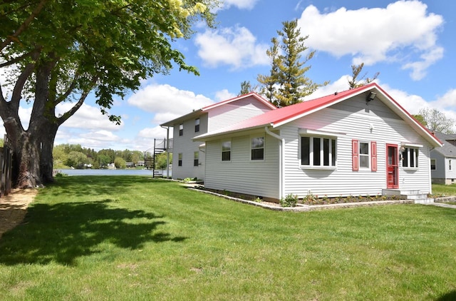2462 Wallace Lake Rd, West Bend, WI 53090 - view of side of home featuring a yard and metal roof