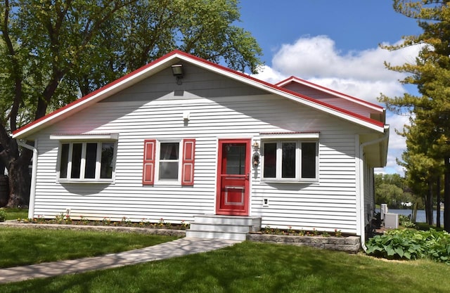 2462 Wallace Lake Rd, West Bend, WI 53090 - bungalow-style house with a front lawn and entry steps