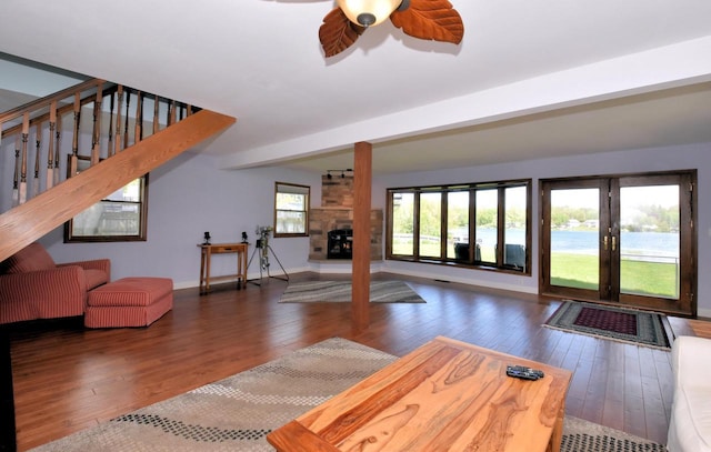 2462 Wallace Lake Rd, West Bend, WI 53090 - living room with hardwood / wood-style floors, a fireplace, ceiling fan, baseboards, and stairs
