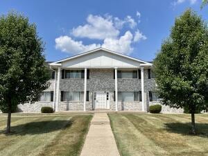 10416 W Whitnall Edge Ct Unit 102, Franklin, WI 53132 - view of front facade with a front lawn and a balcony
