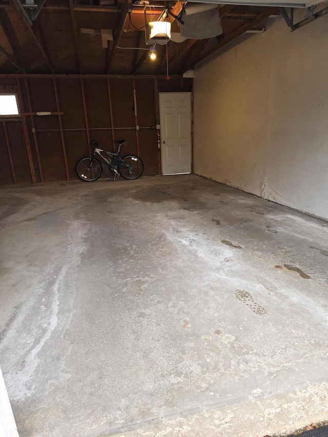 10416 W Whitnall Edge Ct Unit 102, Franklin, WI 53132 - garage featuring a garage door opener