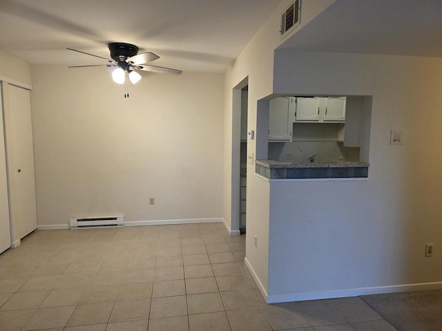 10416 W Whitnall Edge Ct Unit 102, Franklin, WI 53132 - kitchen featuring a baseboard heating unit, ceiling fan, light tile patterned flooring, and baseboards